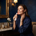 Beautiful woman using Velvoria Radiance RF Microcurrent Face Lifting Device on her jawline